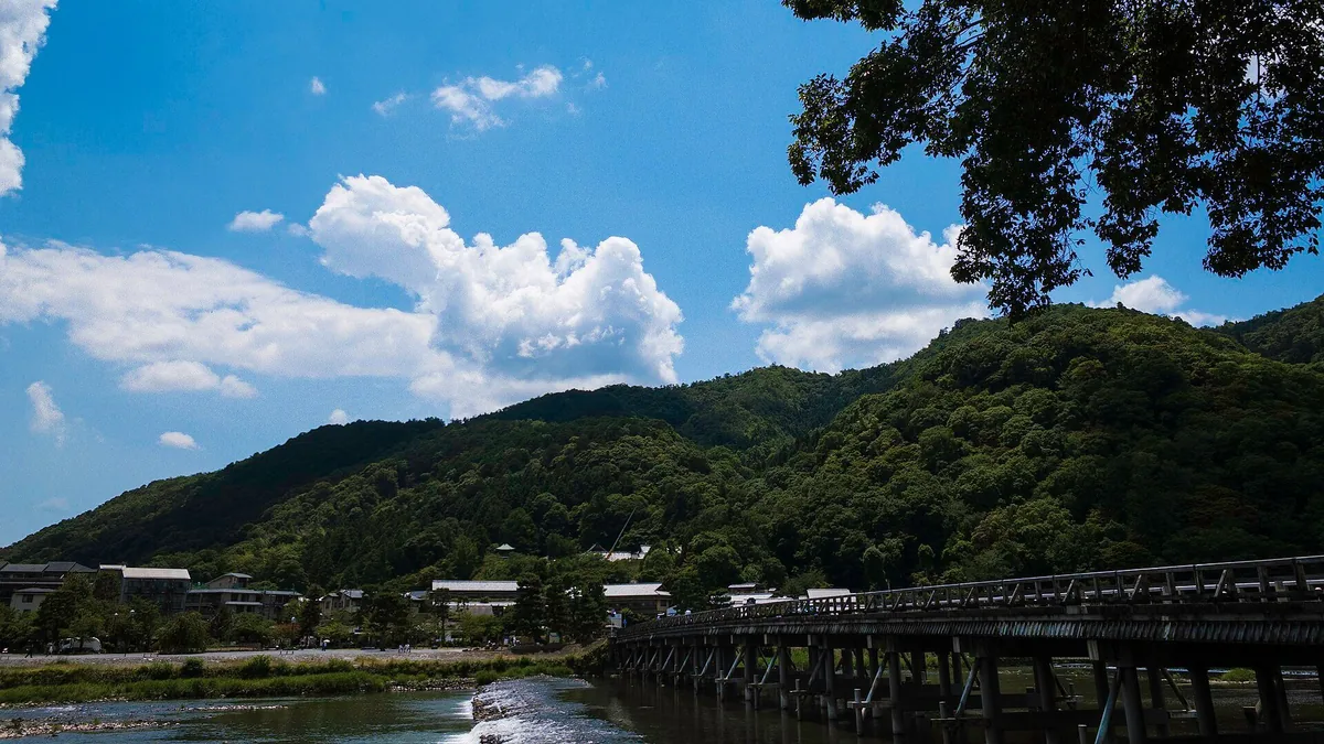 Togetsukyo Bridge crossing the Katsura River below the green mountains of Arashiyama