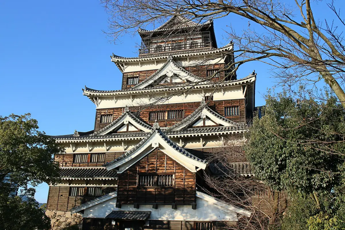Front-facing view of Hiroshima Castle keep framed by winter trees