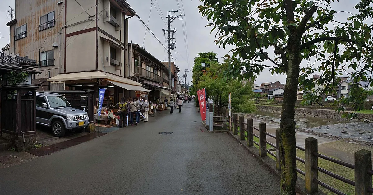 Riverside stalls and visitors at Miyagawa Morning Market in Takayama