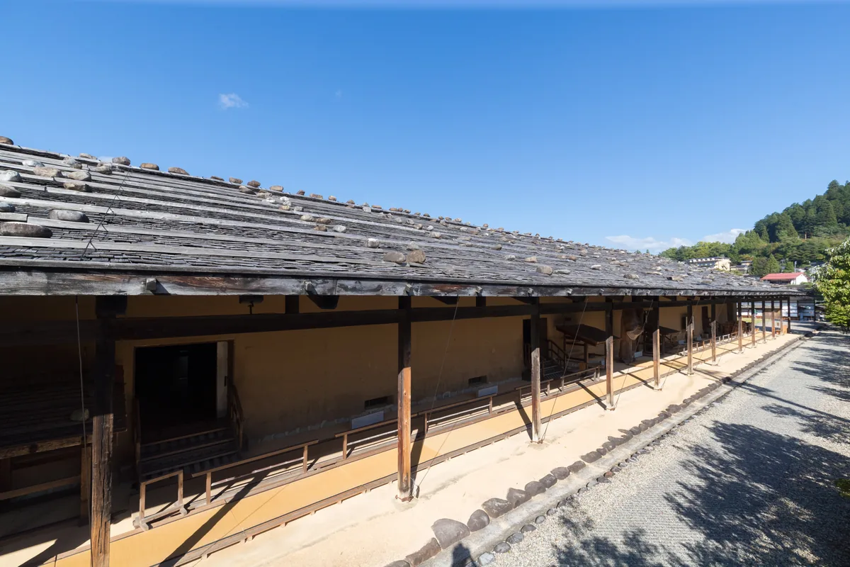 Long low wooden exterior building within the Takayama Jinya complex