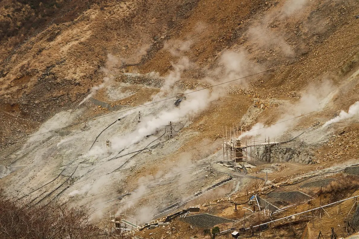 Steam rising from the volcanic slopes and geothermal infrastructure at Owakudani